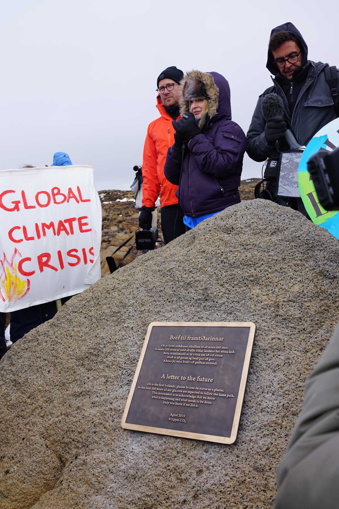 Funeral ceremony of Ok-jökull glacier 18 August 2019. Professor Cymene Howe addressing the crowd, Andri Snær Magnason, author of plaque text, standing by. Photo by Oddur Sigurðsson.